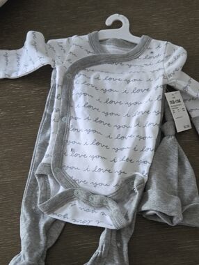 cloud island baby tag with light blue cloud and gray text